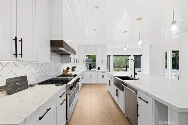 a kitchen with kitchen island granite countertop lots of counter top space and stainless steel appliances