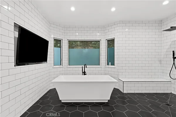 a bathroom with a sink a mirror and bathtub