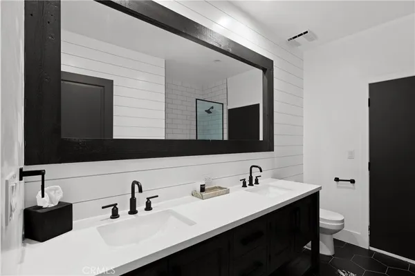 a bathroom with a sink double vanity and a mirror