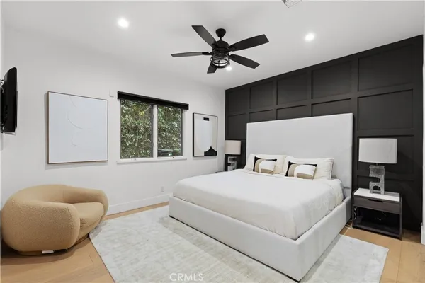 a bedroom with a large bed and a window