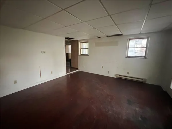 an empty room with a empty space and windows