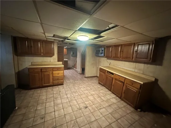 a large kitchen with a stove a sink dishwasher and a refrigerator