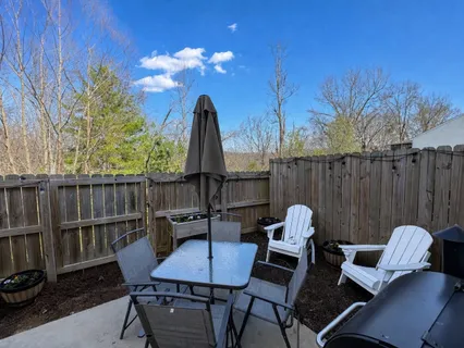 a view of a backyard with furniture and a tub
