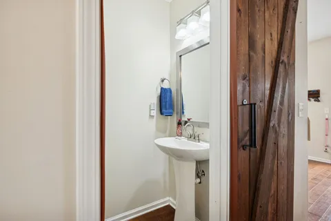 a bathroom with a sink mirror and toilet