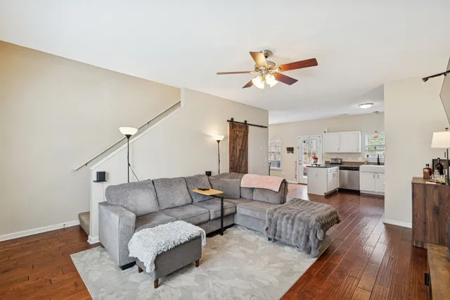 a living room with furniture and kitchen view
