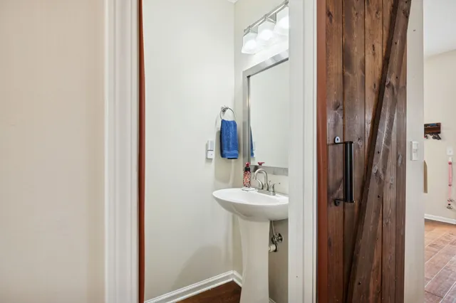 a bathroom with a sink mirror and toilet