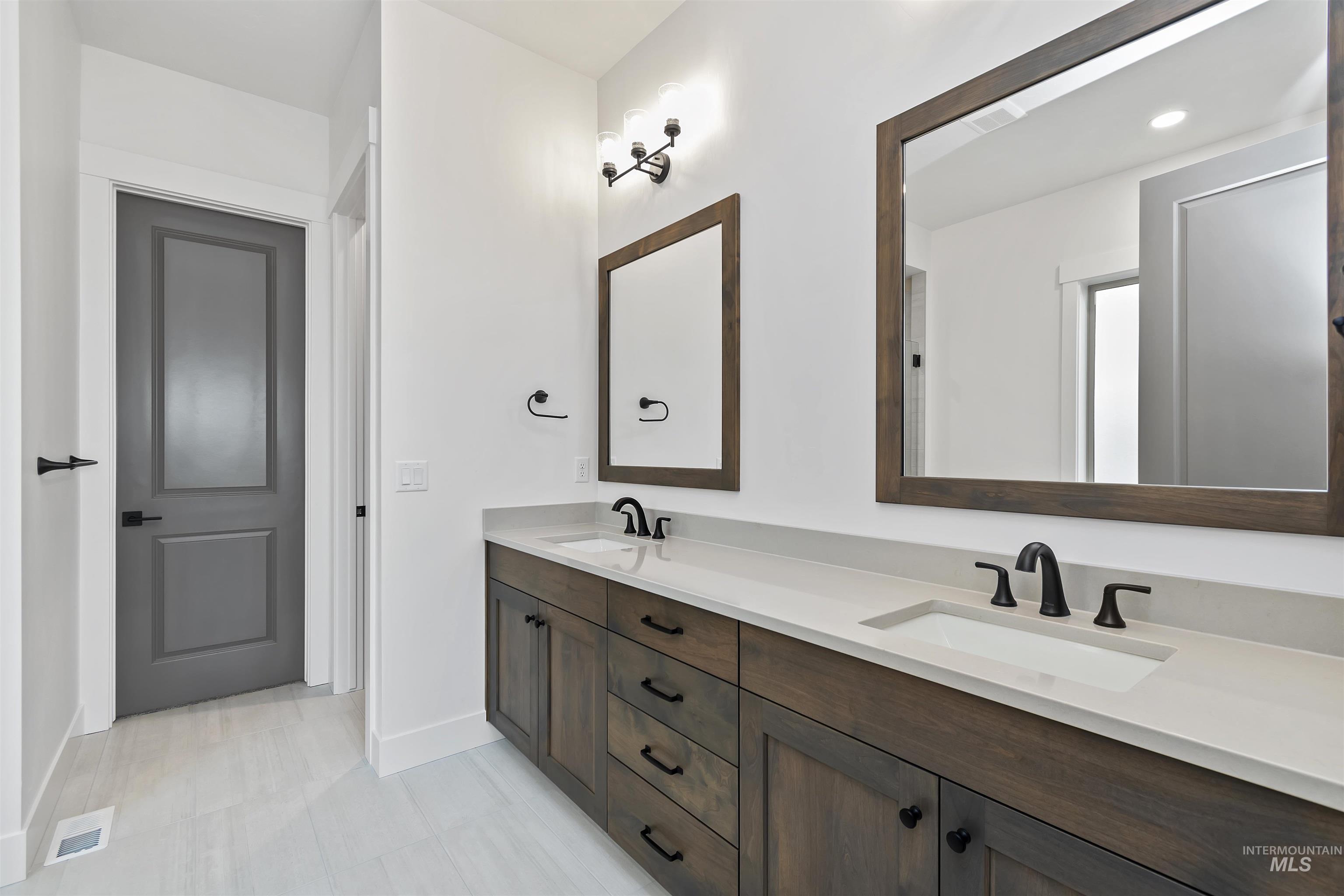 3875 South Corabell Avenue Meridian, ID 83642 - Photo 14 of 27 Bathroom featuring double vanity and baseboards