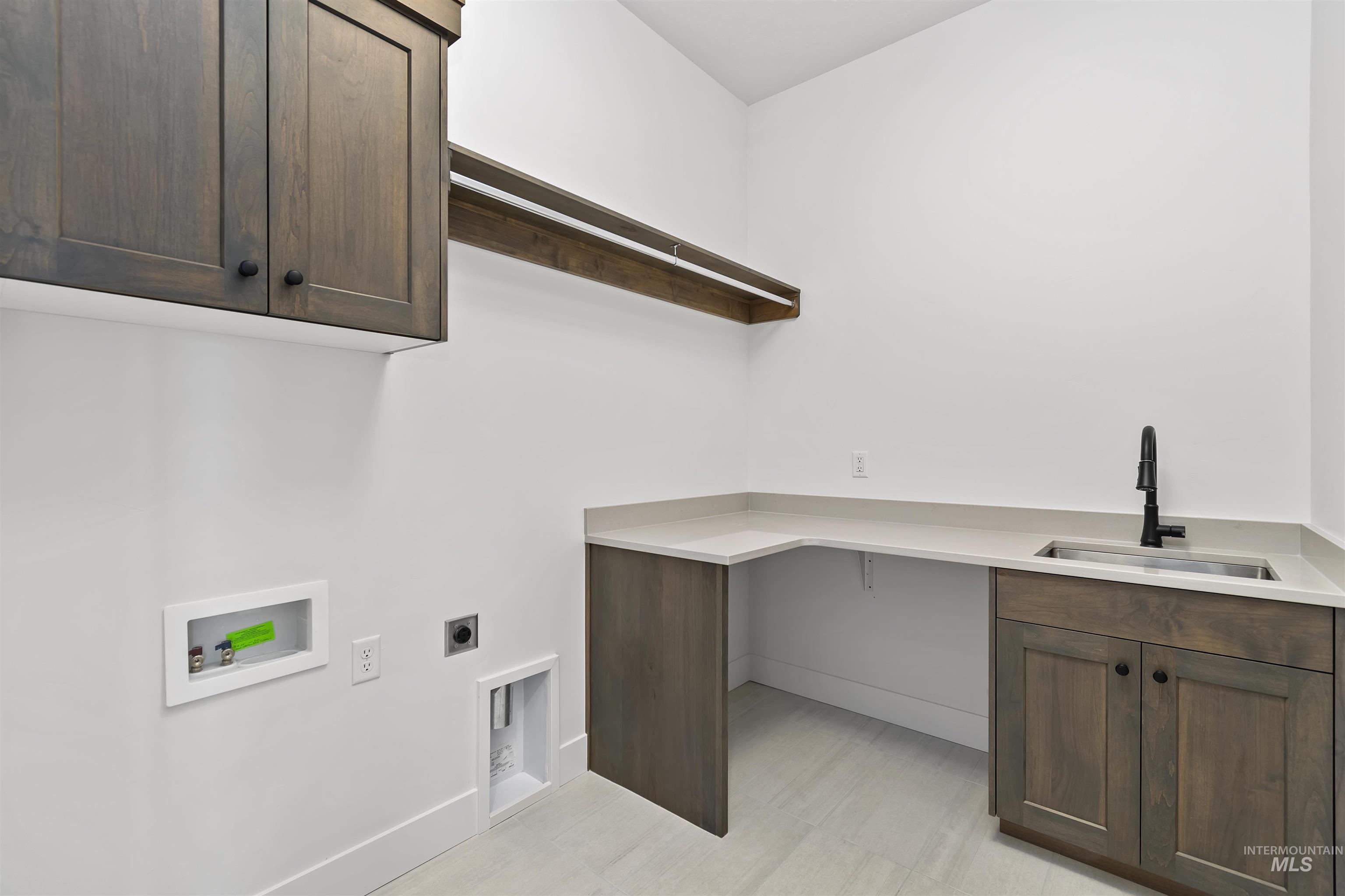 3875 South Corabell Avenue Meridian, ID 83642 - Photo 23 of 27 Laundry room featuring cabinet space, hookup for an electric dryer, hookup for a washing machine, and light flooring