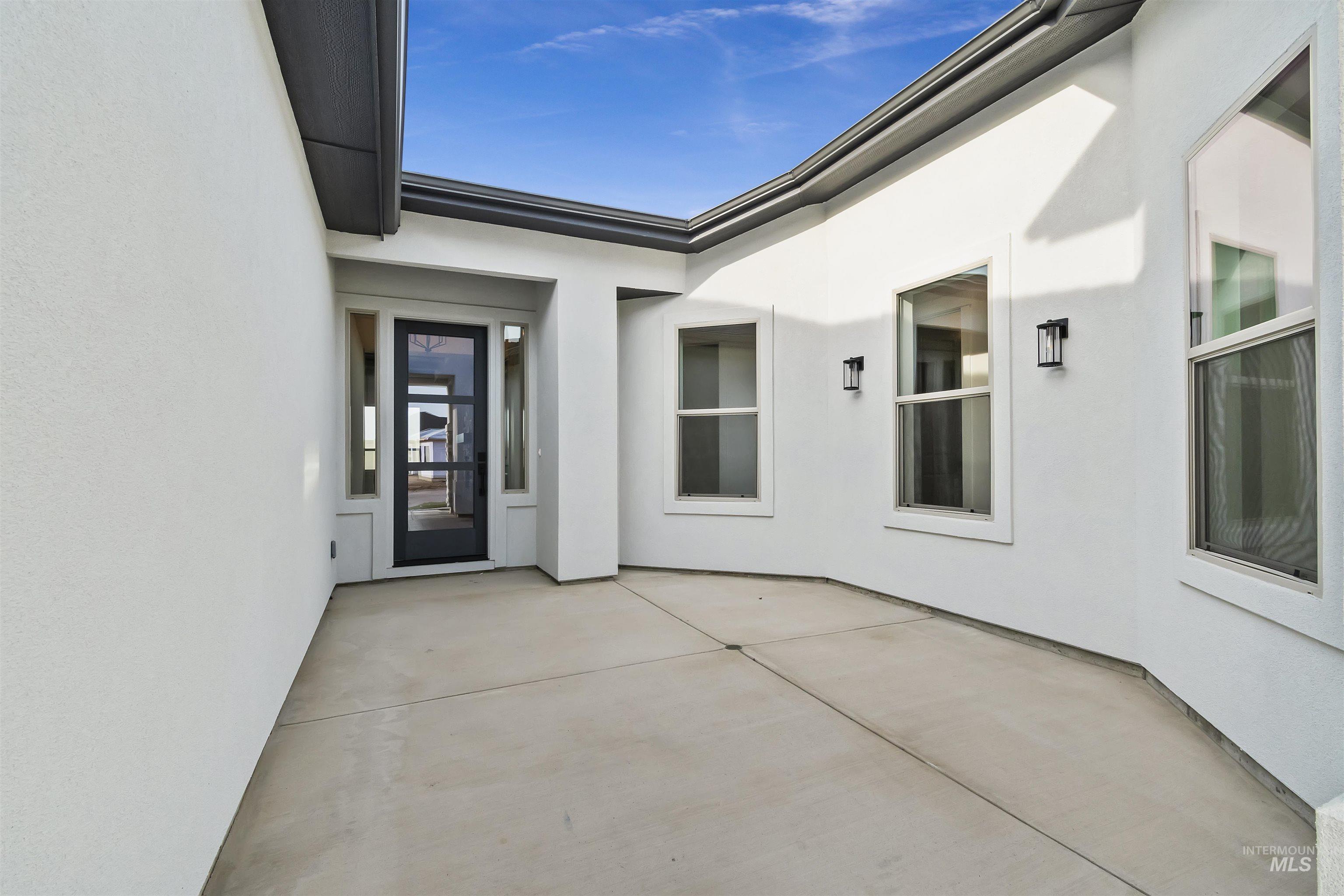 3875 South Corabell Avenue Meridian, ID 83642 - Photo 4 of 27 Entrance to property with stucco siding and a patio