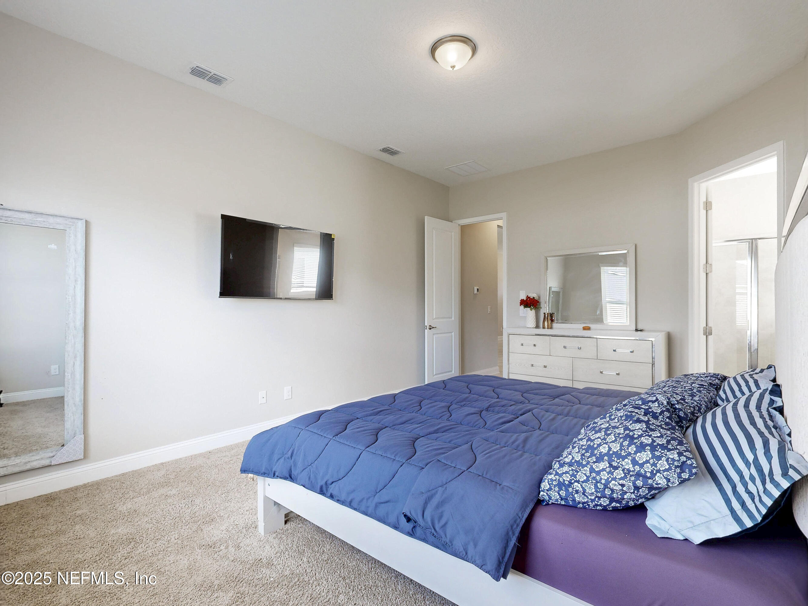 158 Holly Rdg Way St. Augustine, FL 32092 - Photo 11 of 46 a bedroom with a large bed and a flat screen television