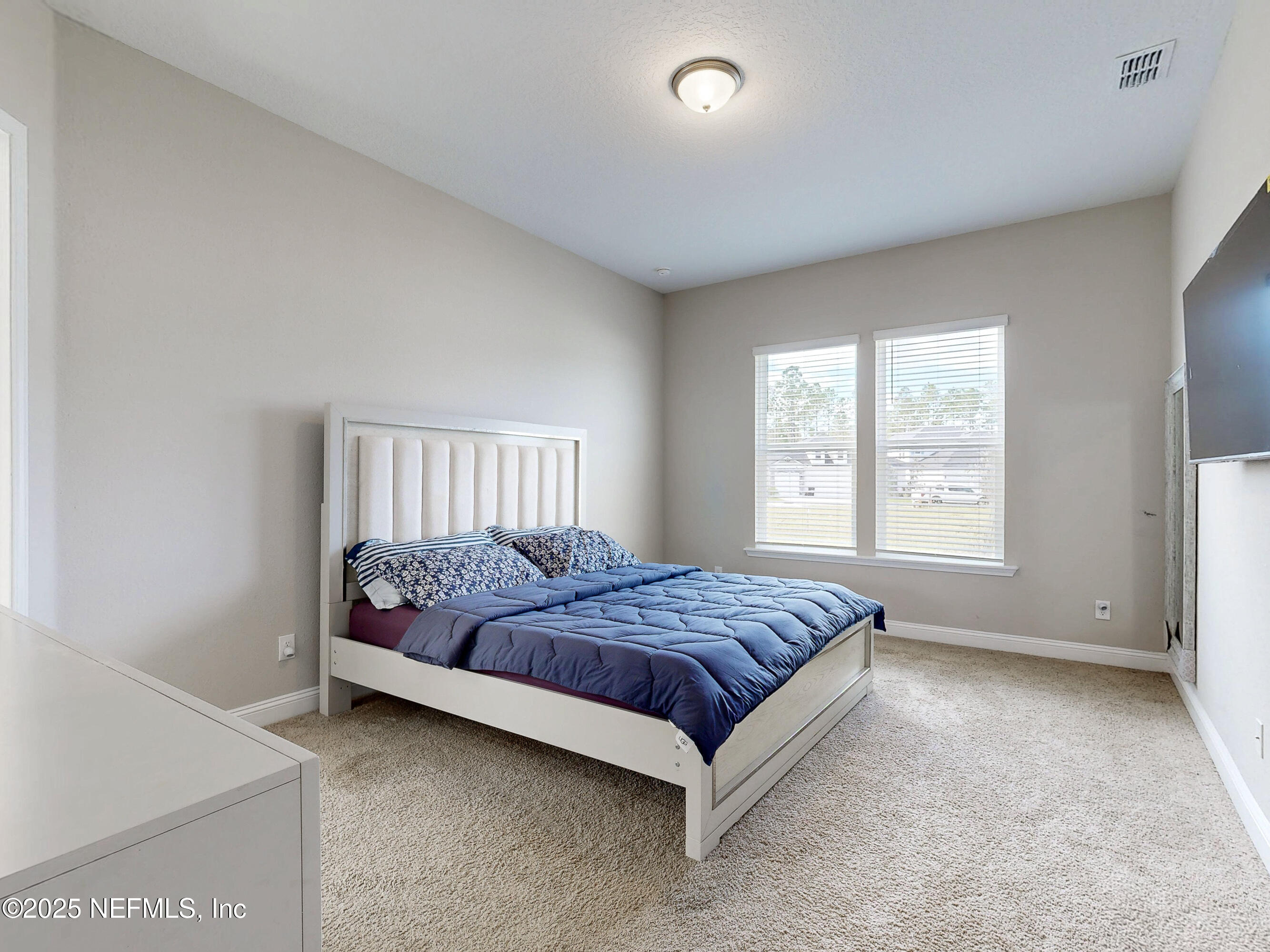 158 Holly Rdg Way St. Augustine, FL 32092 - Photo 12 of 46 a bed sitting in a bedroom next to a window