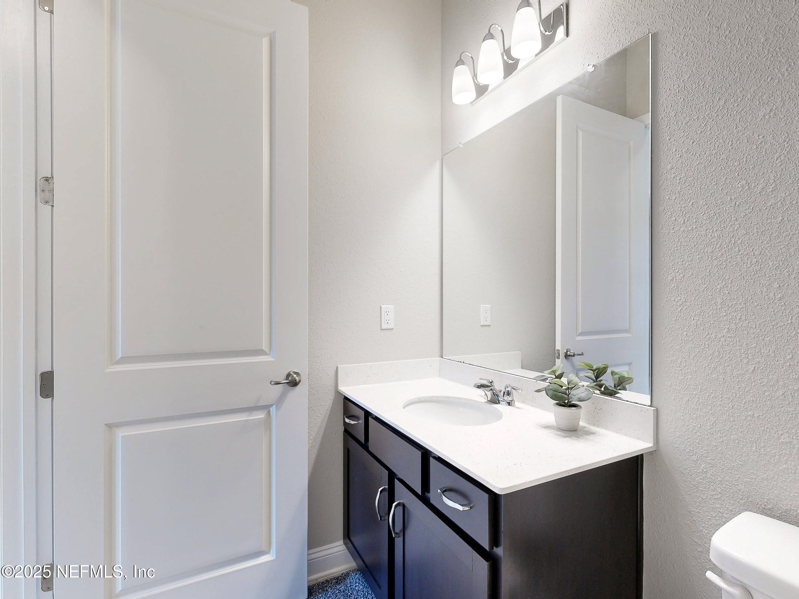 158 Holly Rdg Way St. Augustine, FL 32092 - Photo 23 of 46 a bathroom with a sink vanity and a mirror