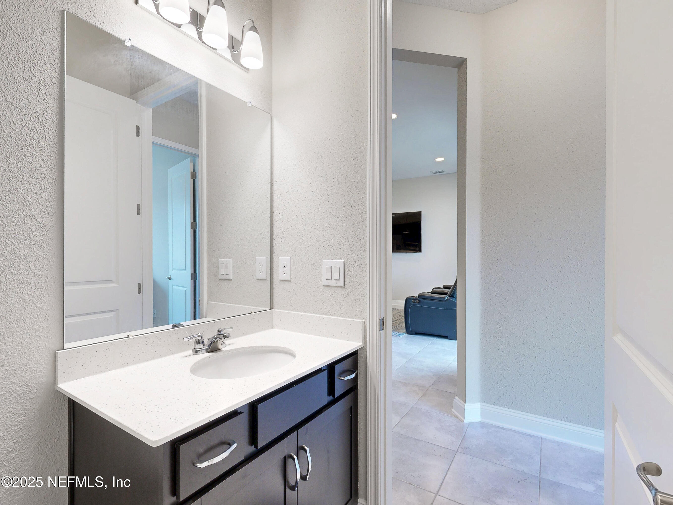 158 Holly Rdg Way St. Augustine, FL 32092 - Photo 27 of 46 a bathroom with a sink a light fixture and a mirror