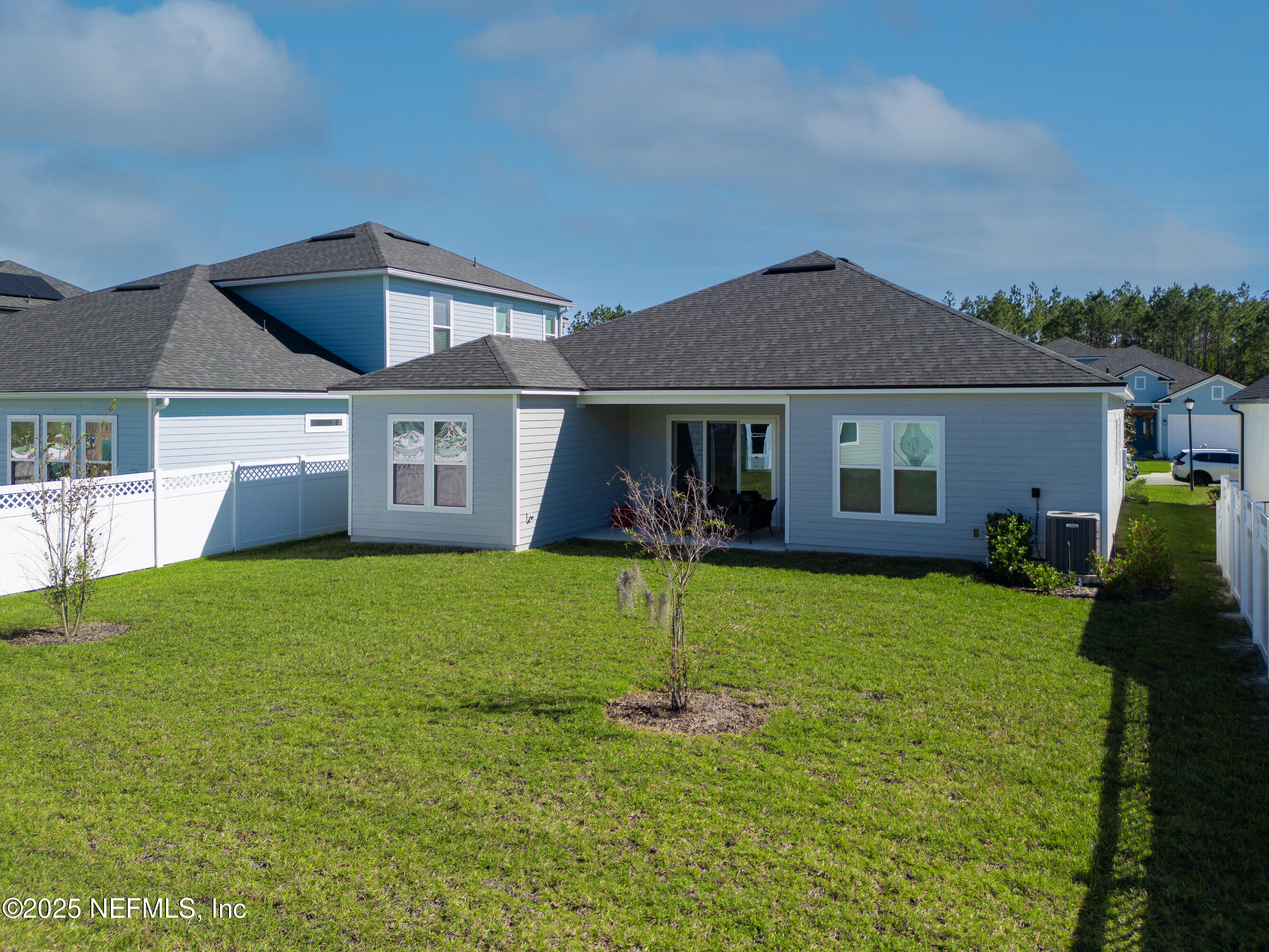 158 Holly Rdg Way St. Augustine, FL 32092 - Photo 33 of 46 a front view of a house with a garden and yard