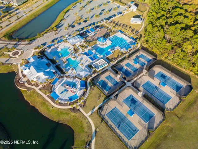 an aerial view of residential houses with outdoor space