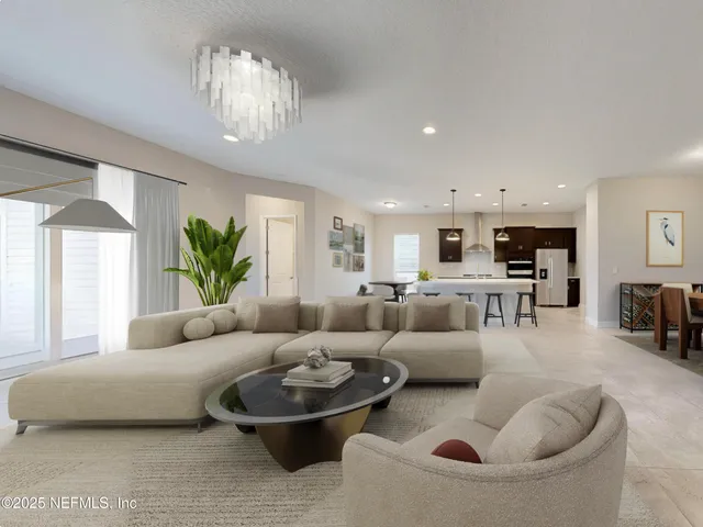 a living room with furniture and a chandelier