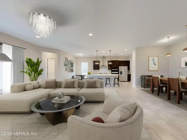 a living room with furniture and a chandelier