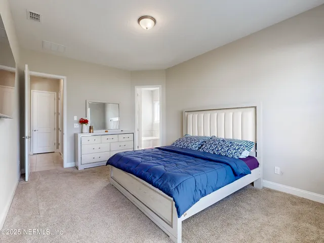 a bedroom with a large bed and a couch