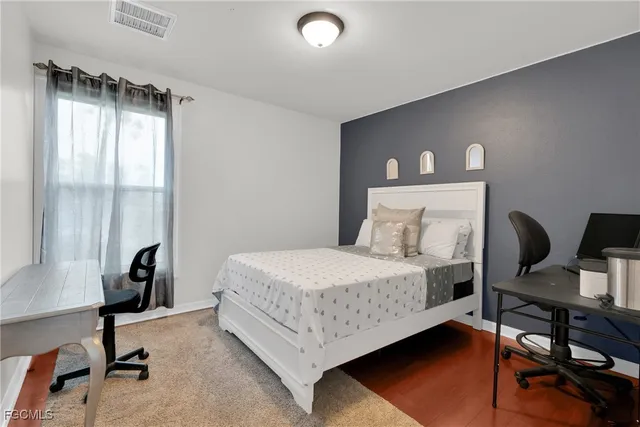 a bedroom with a bed and a dresser