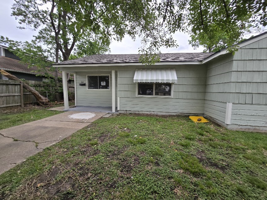 822 Woodhue Street Channelview, TX 77530 - Photo 1 of 14 a view of a house with a yard