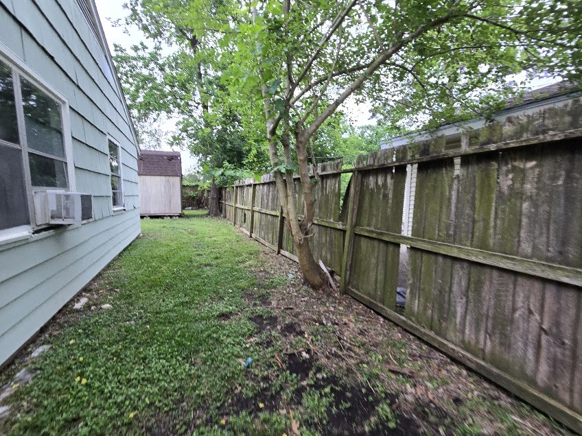 822 Woodhue Street Channelview, TX 77530 - Photo 12 of 14 a view of backyard with wooden fence and large trees