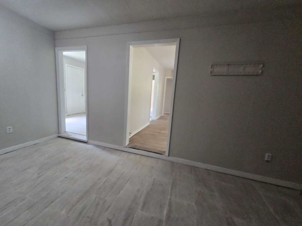 822 Woodhue Street Channelview, TX 77530 - Photo 5 of 11 an empty room with closet and windows