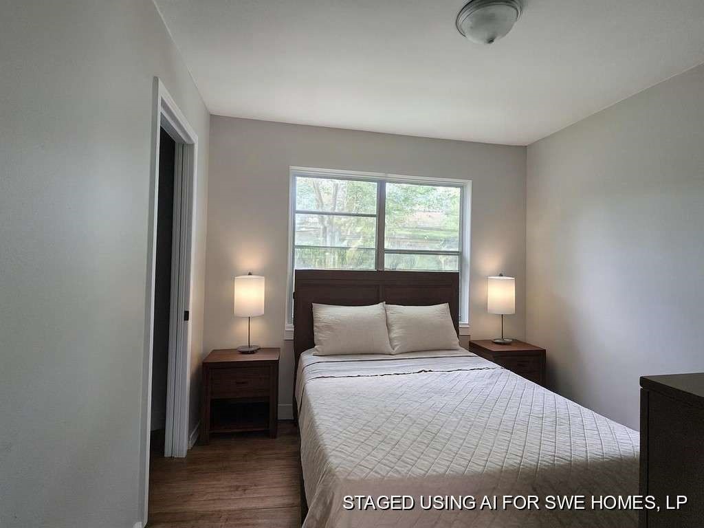 822 Woodhue Street Channelview, TX 77530 - Photo 10 of 14 a bedroom with a bed and window