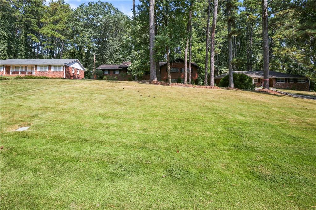2763 Hayden Drive Atlanta, GA 30344 - Photo 2 of 11 a swimming pool with trees in the background