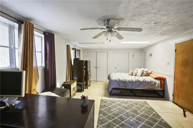 a bedroom with furniture and a flat screen tv