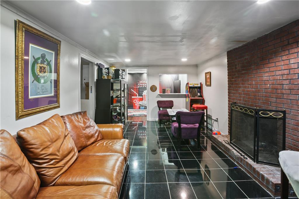 2763 Hayden Drive Atlanta, GA 30344 - Photo 6 of 11 a living room with furniture a flat screen tv and a fireplace