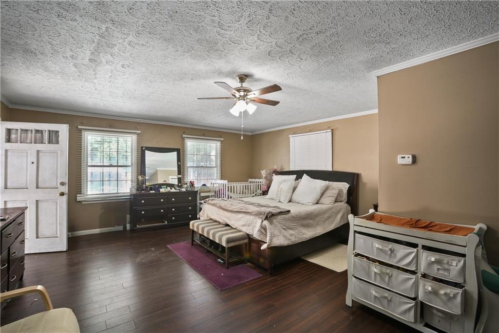 2763 Hayden Drive Atlanta, GA 30344 - Photo 7 of 11 a spacious bedroom with a bed and wooden floor