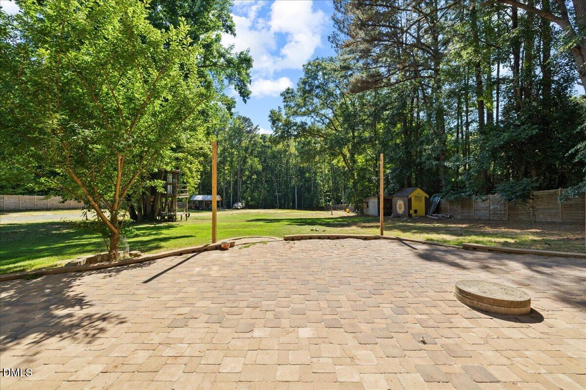 1304 Flying Hawk Road Apex, NC 27523 - Photo 38 of 52 a view of a swimming pool with a yard