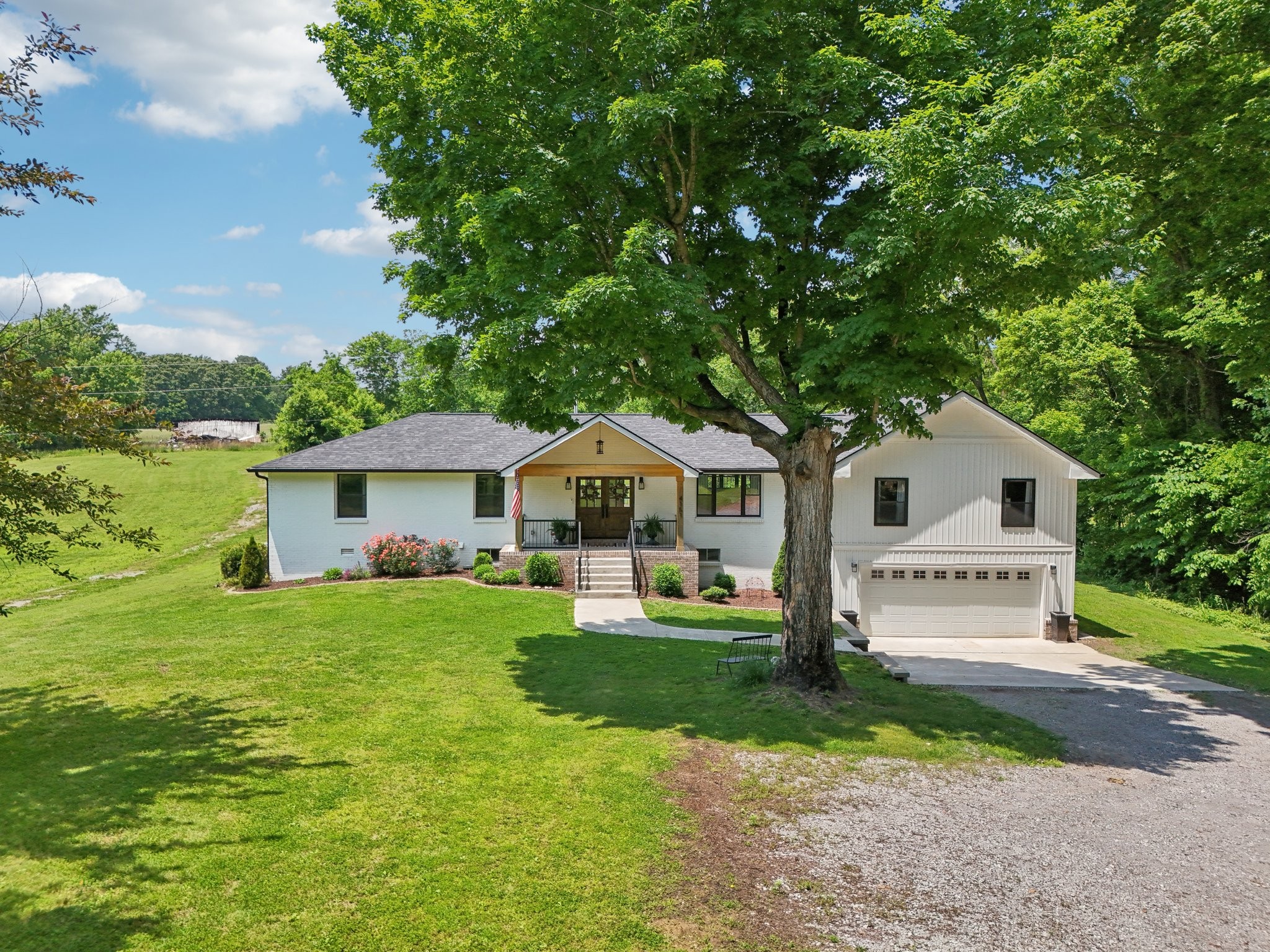 4151 Sadlersville Road Adams, TN 37010 - Photo 3 of 64 a front view of a house with a yard and garage