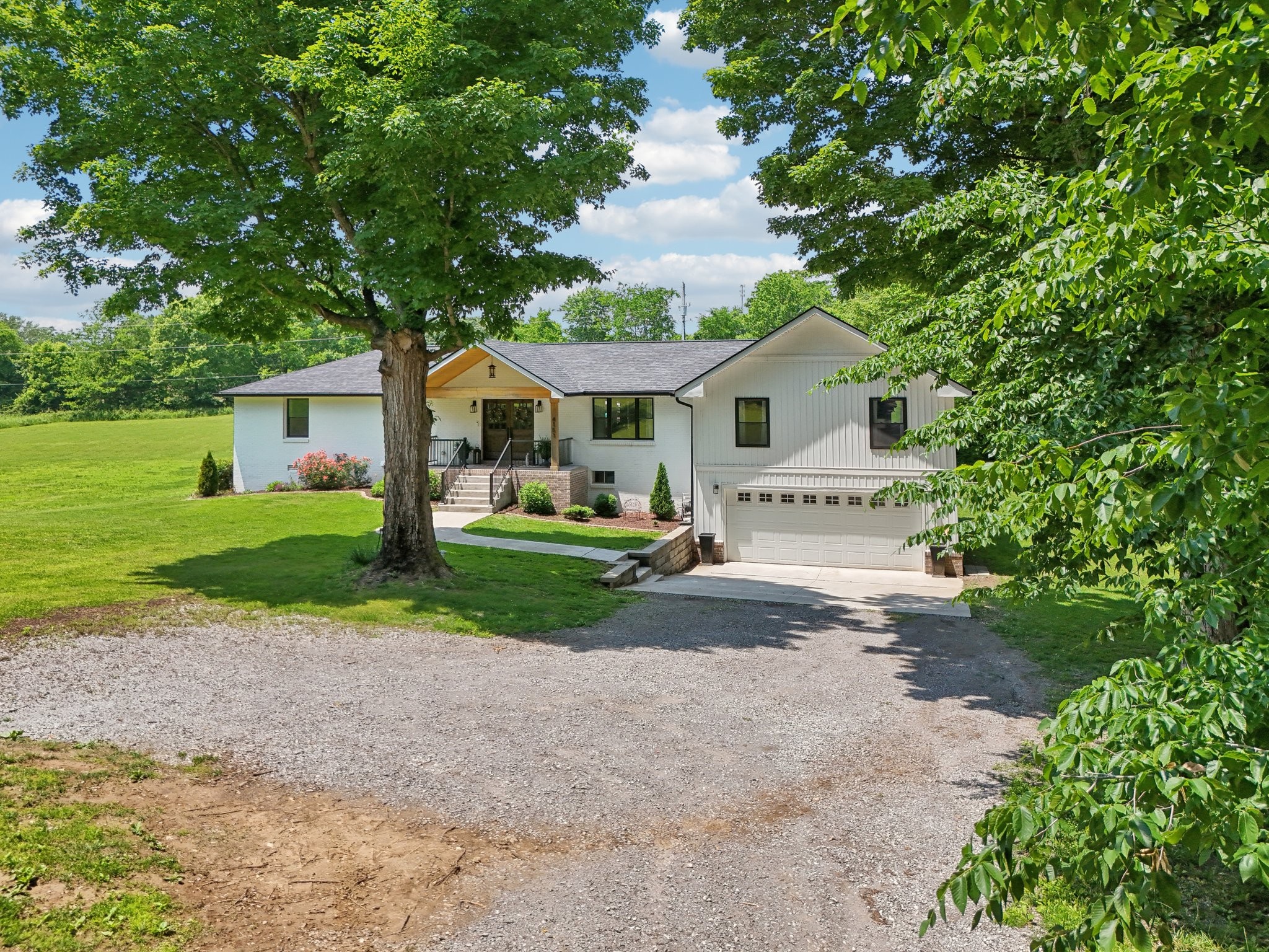 4151 Sadlersville Road Adams, TN 37010 - Photo 53 of 64 a front view of a house with a garden and yard