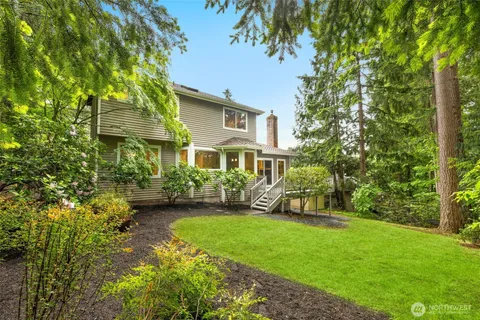 an aerial view of a house with yard