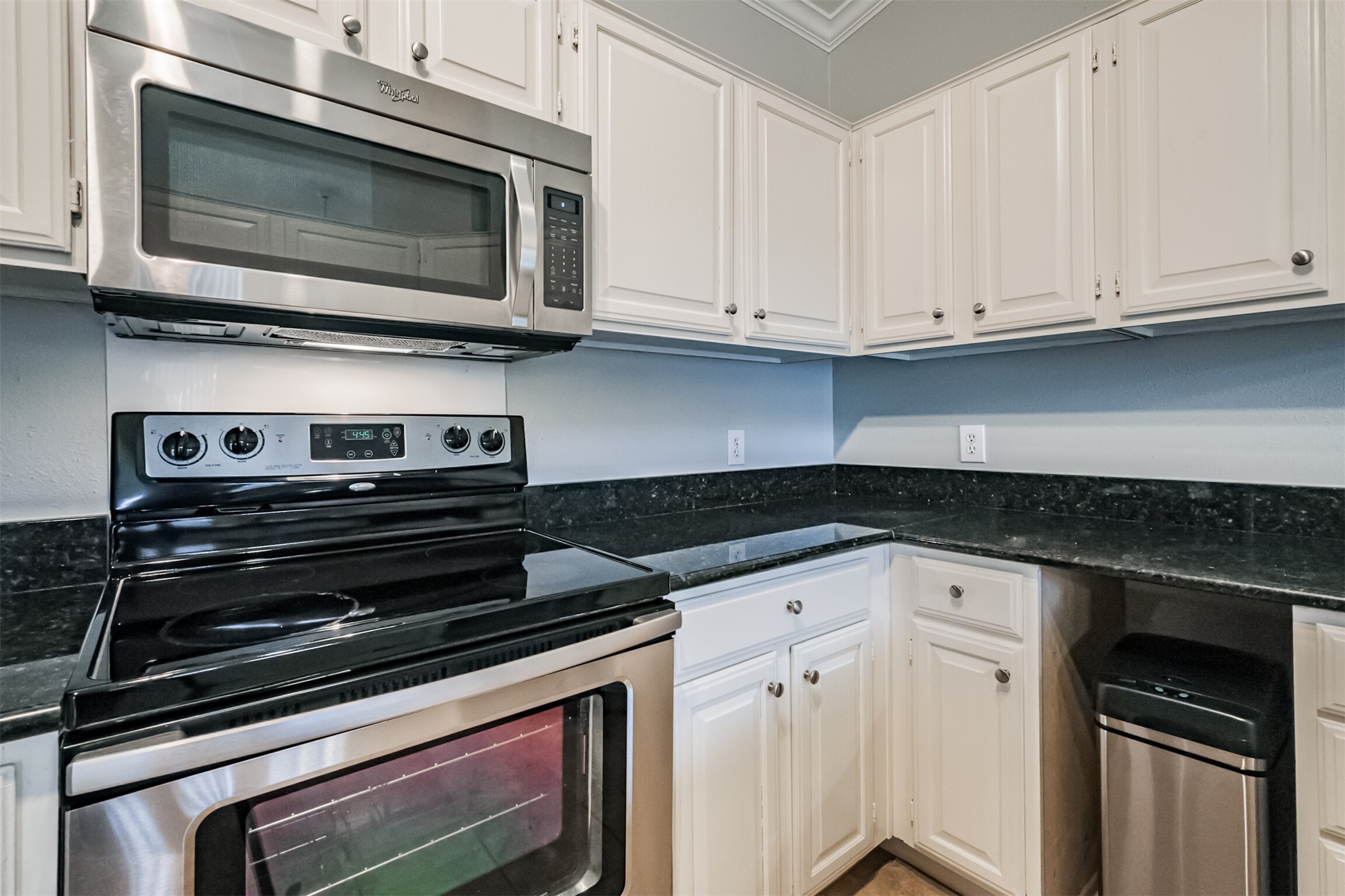 2111 Welch Street, Unit B304 Houston, TX 77019 - Photo 11 of 37 a kitchen with granite countertop white cabinets and stainless steel appliances