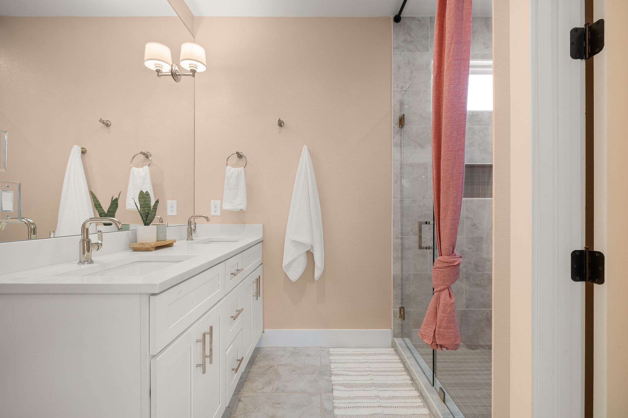 1201 Luna Street Austin, TX 78721 - Photo 19 of 31 Bathroom with double vanity and a stall shower