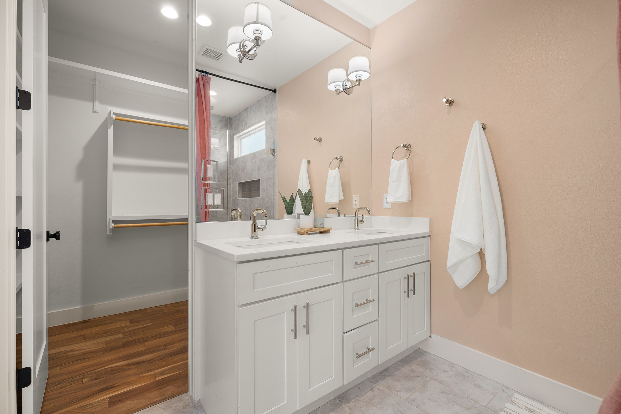1201 Luna Street Austin, TX 78721 - Photo 20 of 31 Bathroom with double vanity and a tile shower