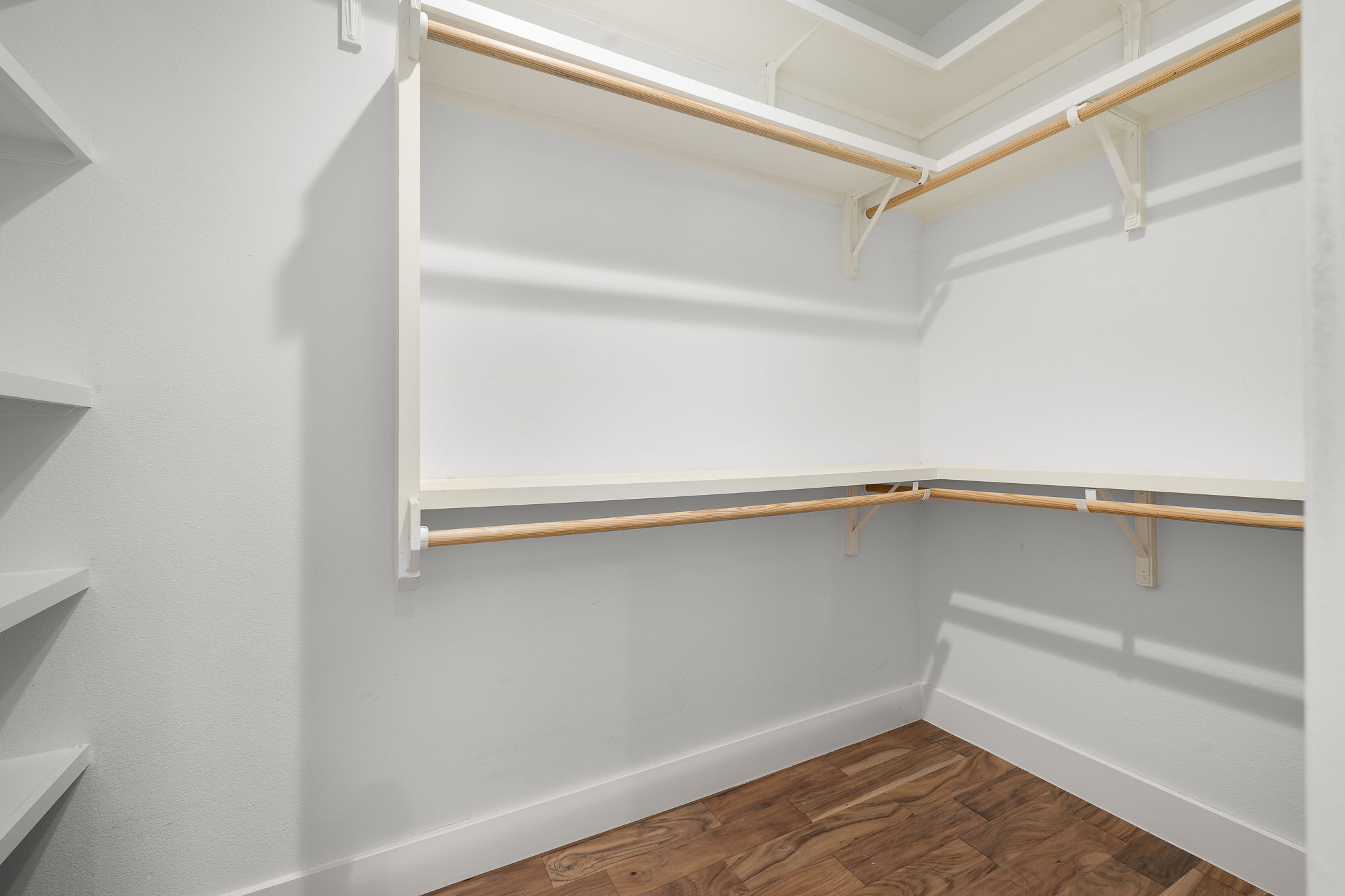 1201 Luna Street Austin, TX 78721 - Photo 22 of 31 Walk in closet featuring dark wood-type flooring