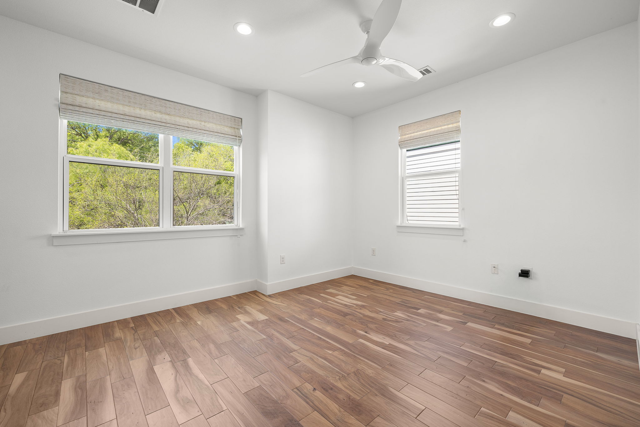 1201 Luna Street Austin, TX 78721 - Photo 23 of 31 Unfurnished room with recessed lighting, wood finished floors, and ceiling fan