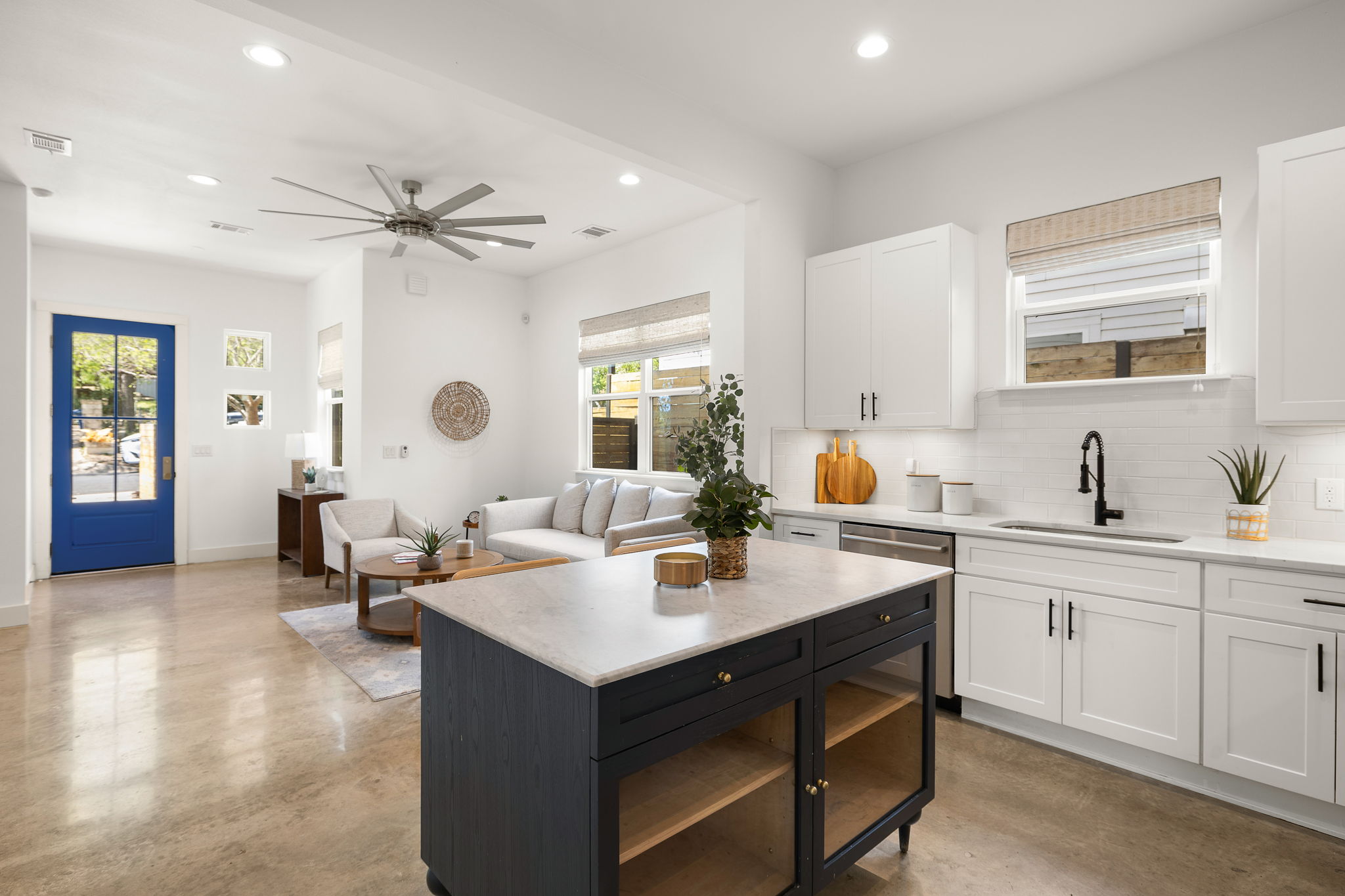 1201 Luna Street Austin, TX 78721 - Photo 31 of 31 Dual tone kitchen featuring concrete floors, two tone color scheme, recessed lighting, open floor plan, and backsplash