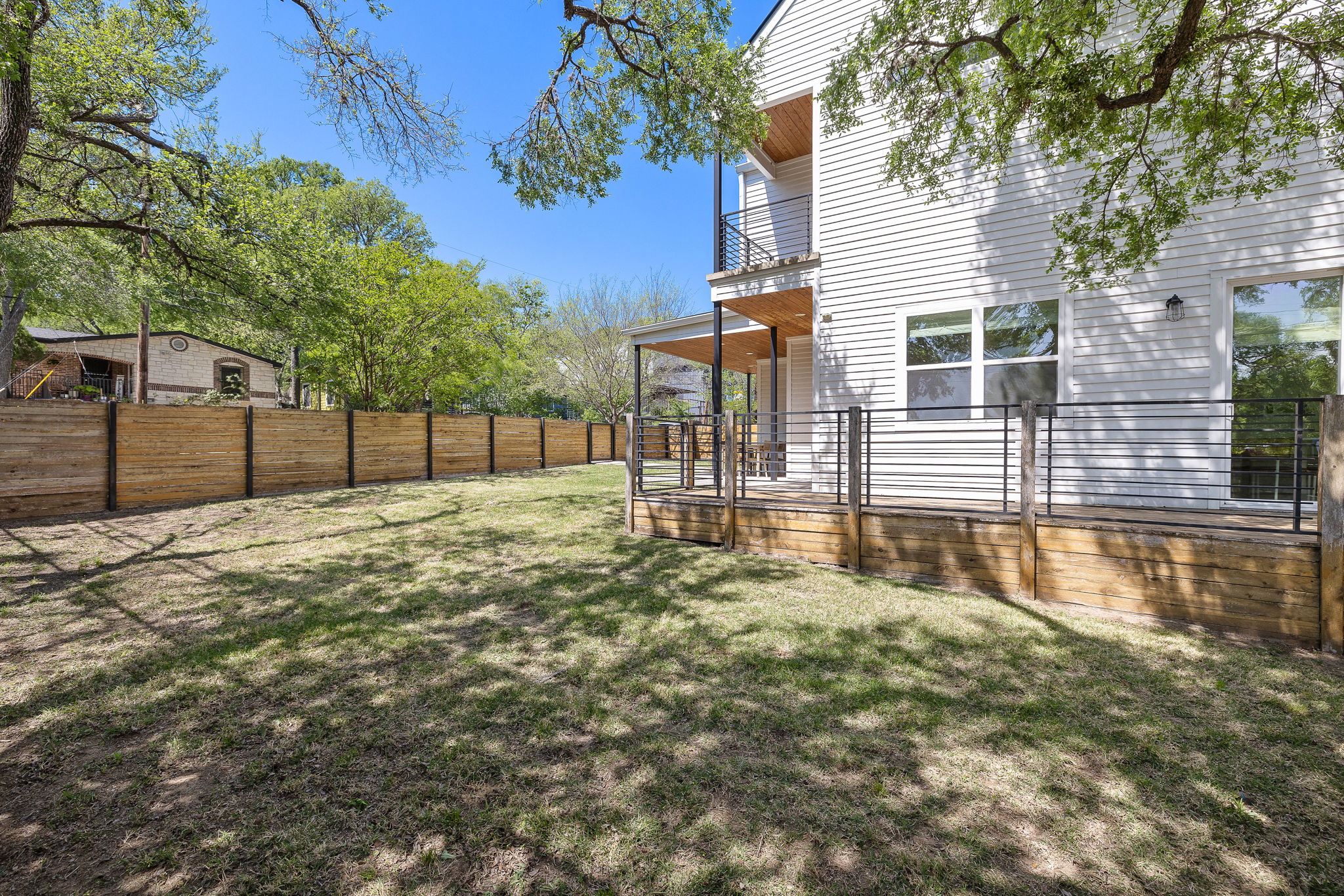 1201 Luna Street Austin, TX 78721 - Photo 8 of 31 Fenced backyard featuring a balcony