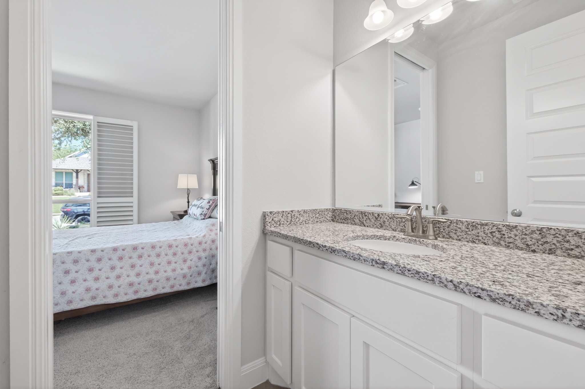 4105 Haight Street Round Rock, TX 78681 - Photo 27 of 40 a bathroom with a granite countertop sink and a mirror