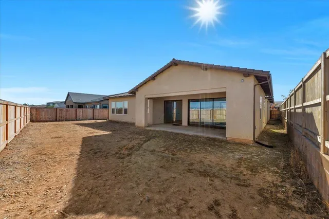 an aerial view of a city with lots of residential buildings ocean and mountain view in back