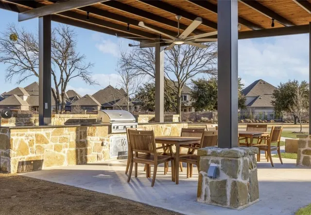 a view of a patio with table and chairs and potted plants