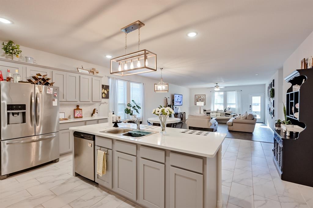 10621 Alpine Meadow Lane Fort Worth, TX 76140 - Photo 13 of 35 a kitchen that has a lot of cabinets a sink and appliances
