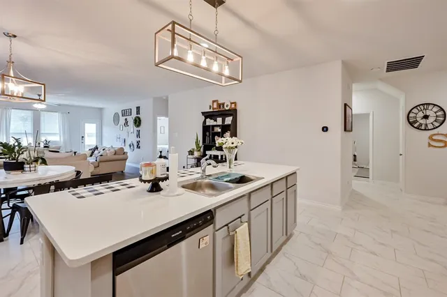 a kitchen with a sink a stove and cabinets