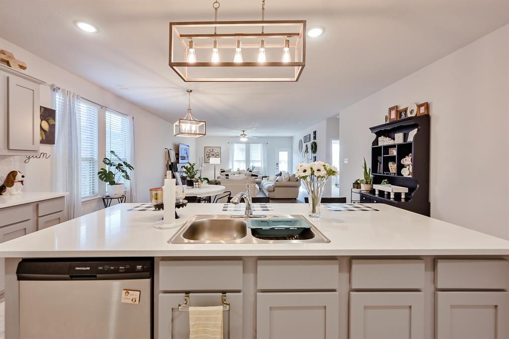 10621 Alpine Meadow Lane Fort Worth, TX 76140 - Photo 17 of 35 a kitchen with a sink a stove and cabinets