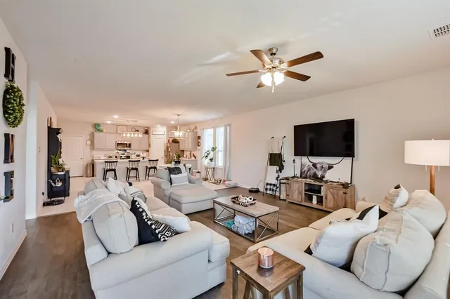 a living room with furniture and view of kitchen