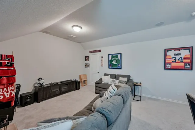 a living room with furniture and a bookshelf